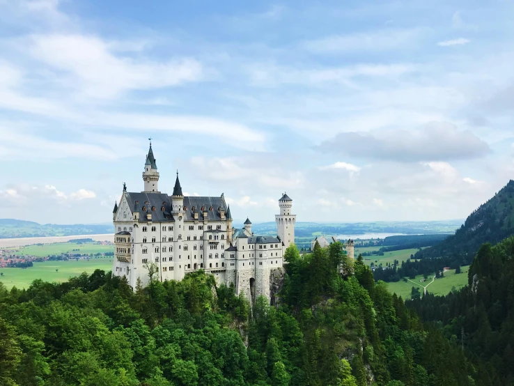 a castle sitting on top of a lush green hillside, pexels contest winner, german romanticism, disney inspired landscape, white, schools, munich