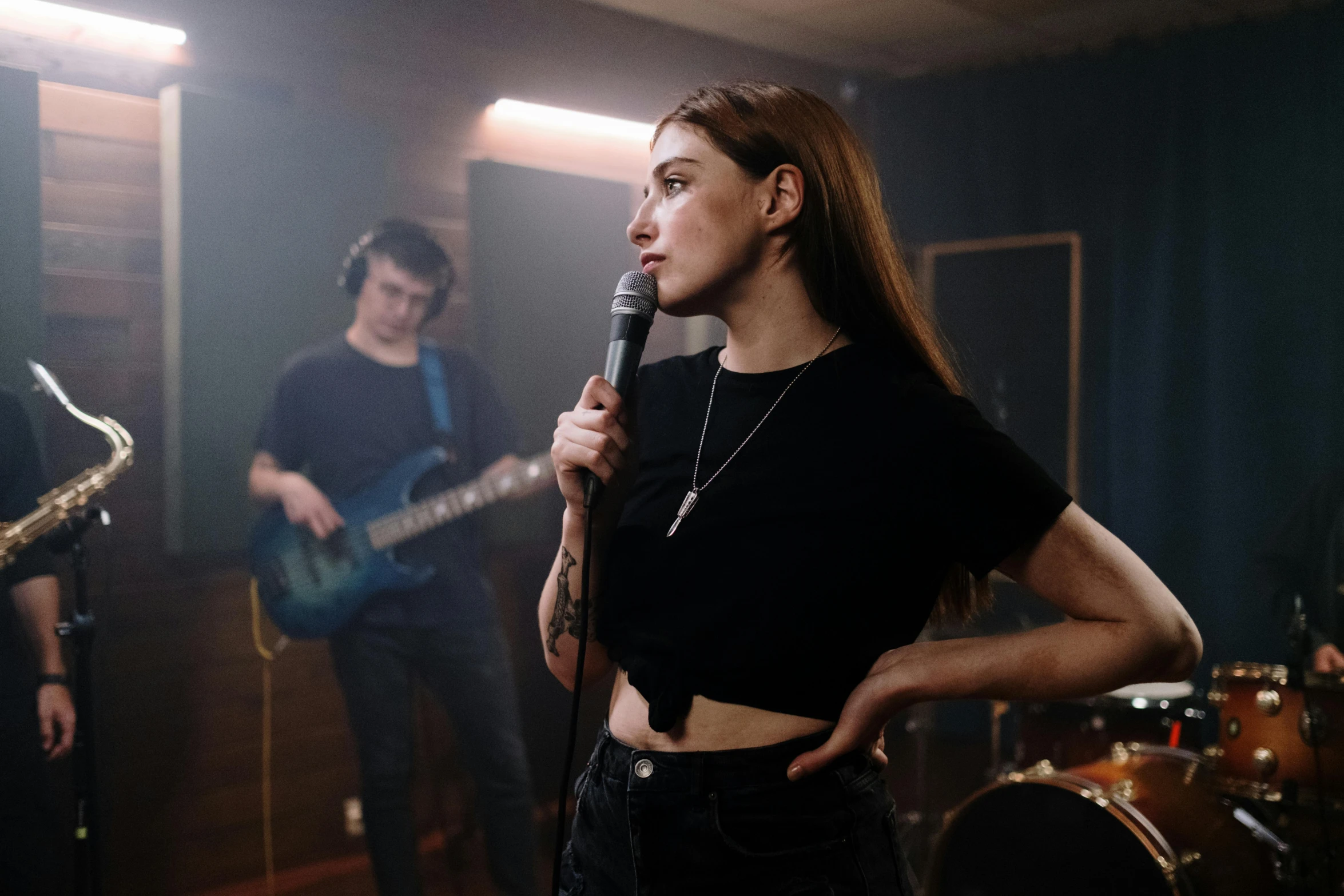 a woman standing next to a man holding a microphone, pexels contest winner, antipodeans, performing a music video, girl in studio, 15081959 21121991 01012000 4k, band