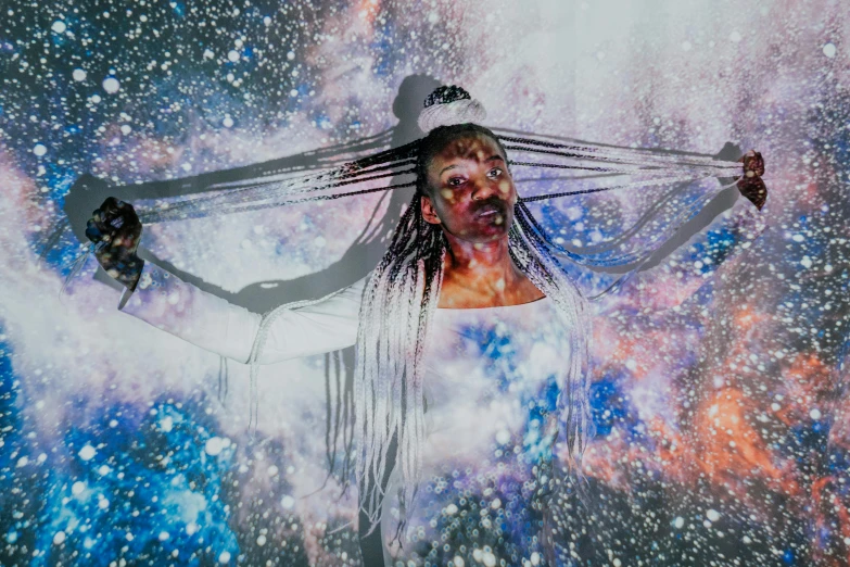 a woman that is standing in the snow, inspired by Dan Hillier, pexels contest winner, afrofuturism, floating in a cosmic nebula, concert, tie-dye, white witch