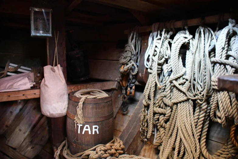 a pile of rope sitting on top of a wooden floor, on a pirate ship, shelves full of medieval goods, straya, slide show