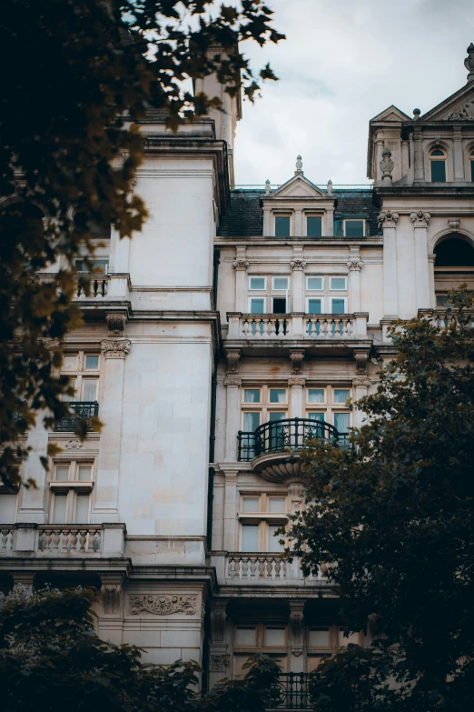 a tall building with lots of windows and balconies, inspired by Mihály Munkácsy, unsplash contest winner, neoclassicism, victorian london, huge mansion, square, 2019 trending photo