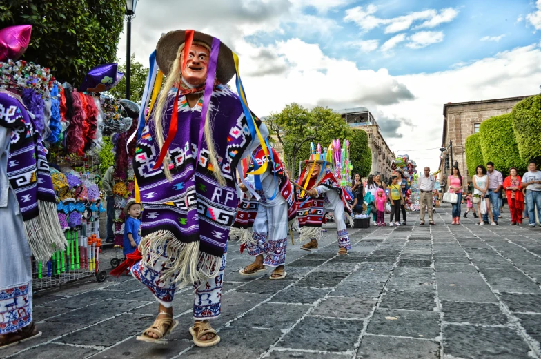 a group of people walking down a street, pexels contest winner, process art, mexican warrior, square, purple, traditional costume