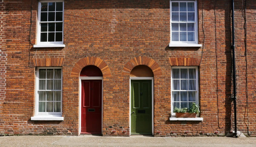 a red brick building with a green door, pexels contest winner, arts and crafts movement, terraced, multi colour, 1 7 8 0, 3 doors