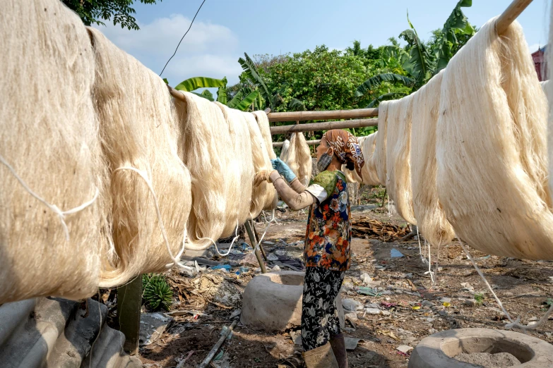 a woman that is standing in the dirt, silk tarps hanging, avatar image, thumbnail, small manufacture