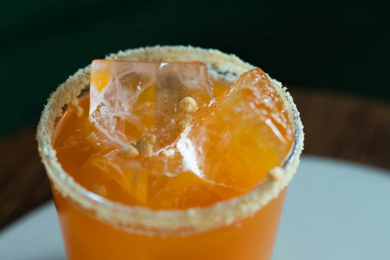 a drink sitting on top of a white plate, thumbnail, orange halo, close up image, fan favorite