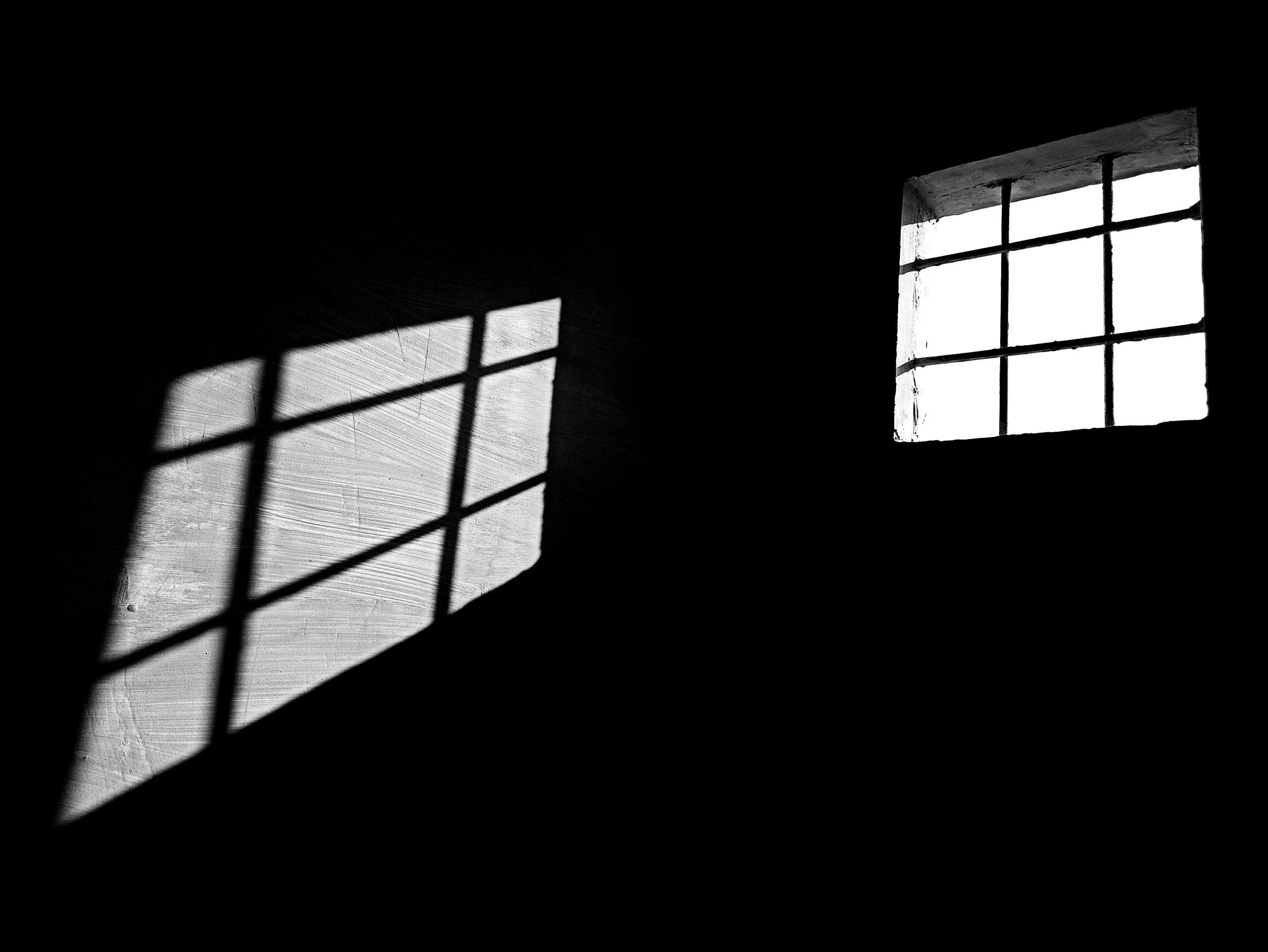 a black and white photo of two windows in a dark room, light and space, squares, egor letov, natural prison light, ffffound