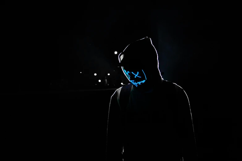 a person wearing a mask in the dark, an album cover, pexels contest winner, digital art, blue leds, anon 5 0 mm, discord profile picture, halloween