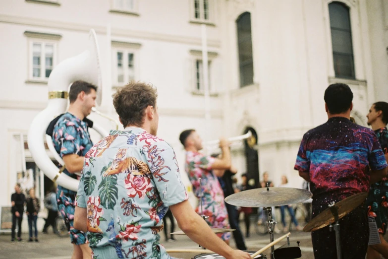 a group of men playing musical instruments in front of a building, by Nina Hamnett, pexels contest winner, funk art, waring a hawaiian shirt, parade, lisbon, youtube thumbnail