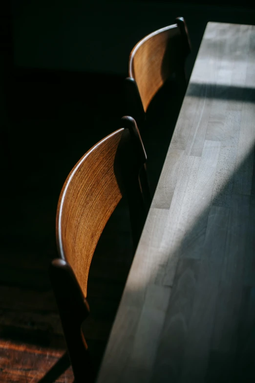 a wooden table sitting on top of a hard wood floor, by Tobias Stimmer, unsplash contest winner, light and space, chairs, dappled in evening light, 15081959 21121991 01012000 4k, nanae kawahara