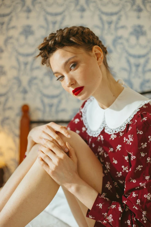 a woman in a red dress sitting on a bed, a portrait, by Lucette Barker, trending on pexels, renaissance, kiko mizuhara, frilled blooming collar, milk bar magazine, patterned clothing