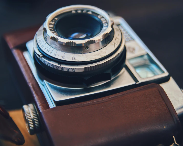 a close up of a camera on a table, vintage aesthetic, colour photo, medium format, top selection on unsplash