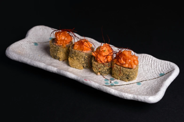 a close up of a plate of food on a table, inspired by Maki Haku, dark grey and orange colours, square, high-quality photo, battered