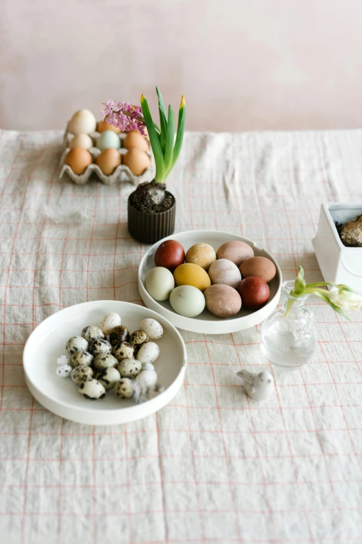 a table topped with bowls filled with eggs, a still life, dwell, holding easter eggs, artisanal art, minna sundberg