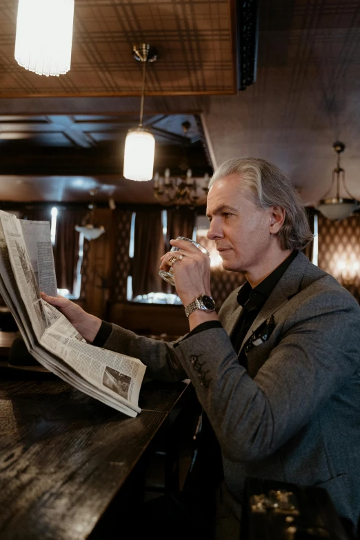 a man sitting at a bar reading a newspaper, an album cover, unsplash, bauhaus, henrik fisker, portrait of sherlock holmes, xqc, meet the actor behind the scenes