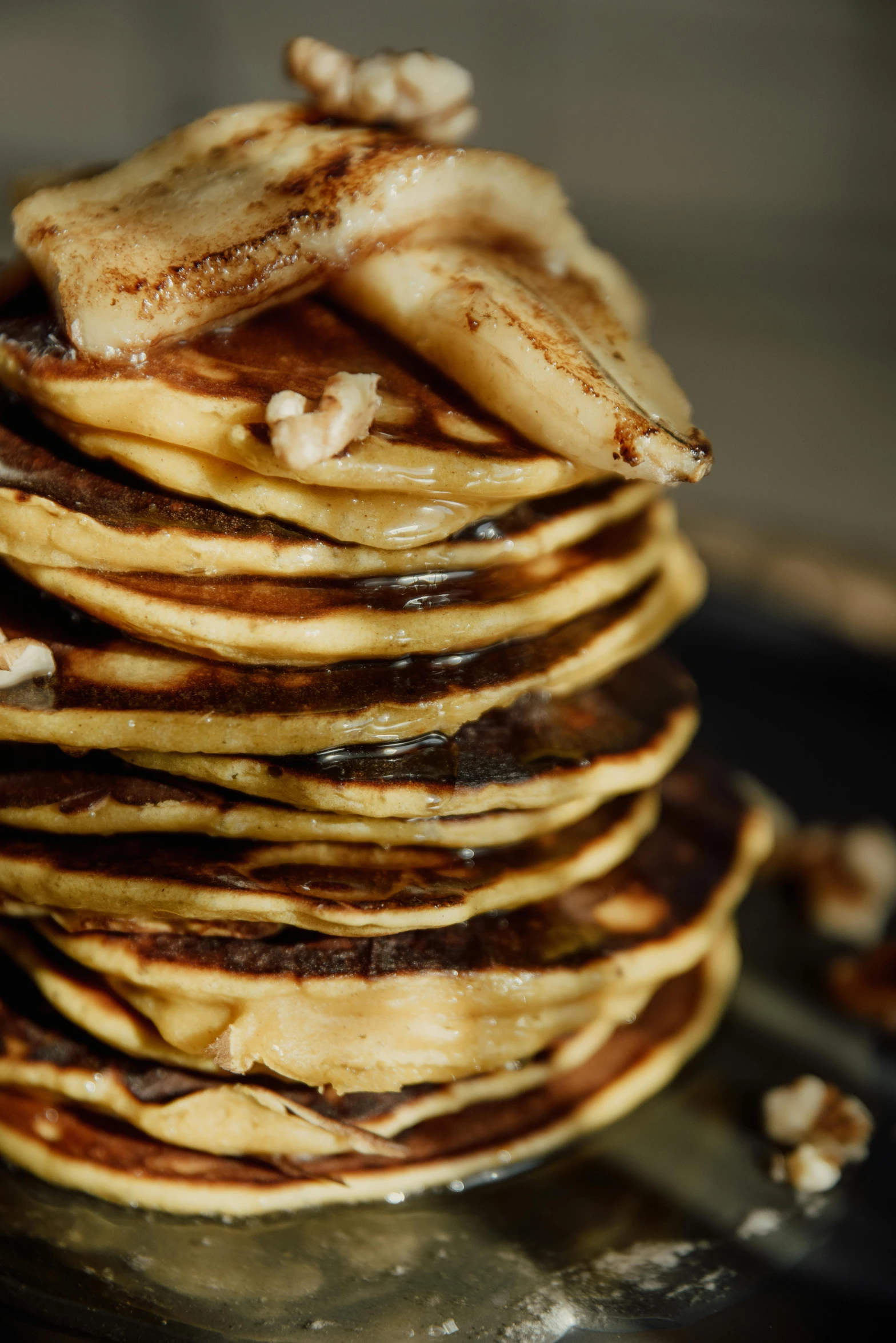 a stack of pancakes sitting on top of a black plate, a portrait, pexels, clumps of bananas, brown, sunlit, thumbnail