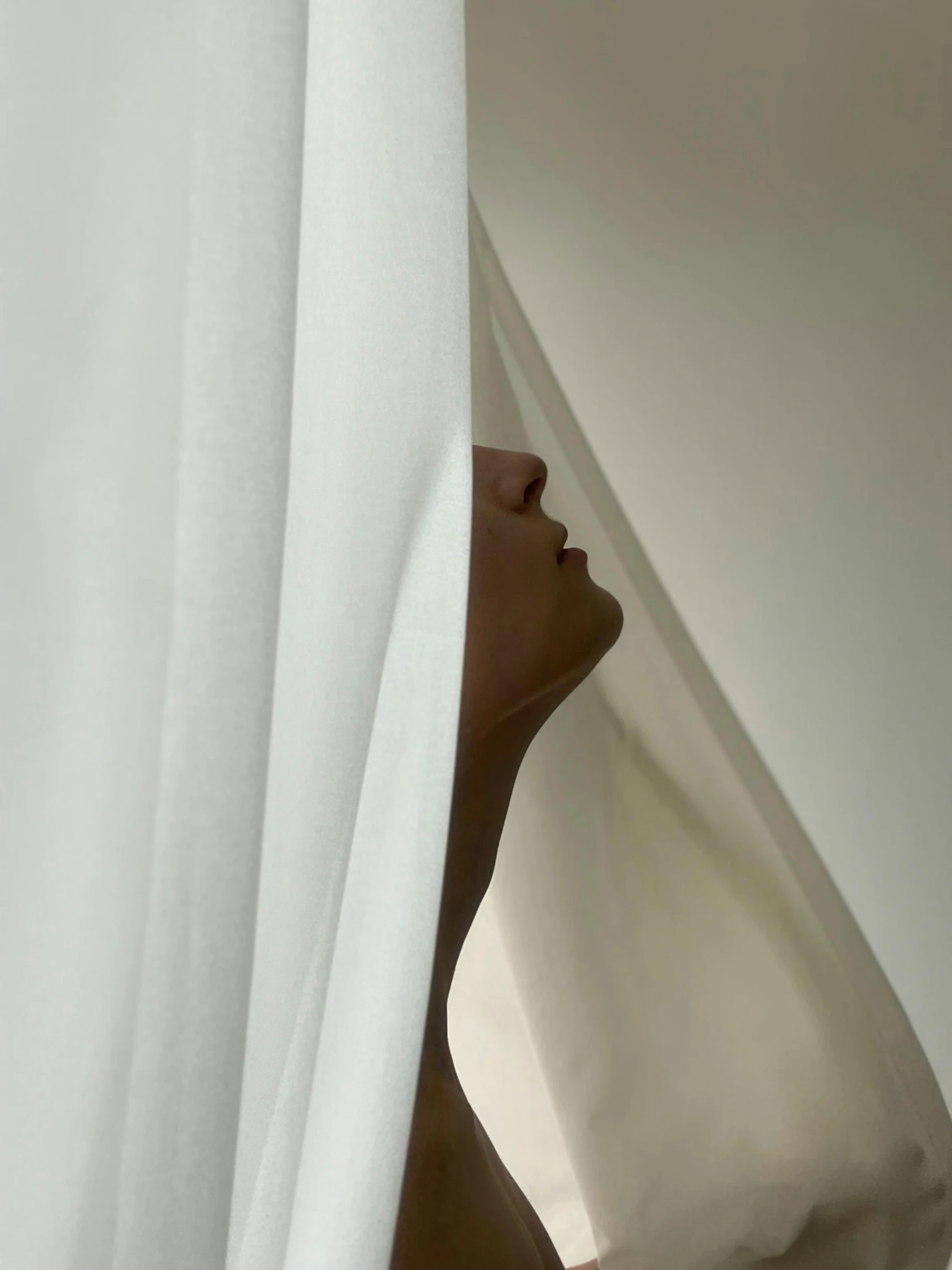 a close up of a person behind a curtain, inspired by Robert Mapplethorpe, aestheticism, white sarong, profile pic, ignant, made of silk paper