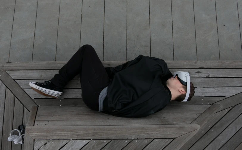a man laying on top of a wooden bench, she is wearing streetwear, face down, blackout, crushed