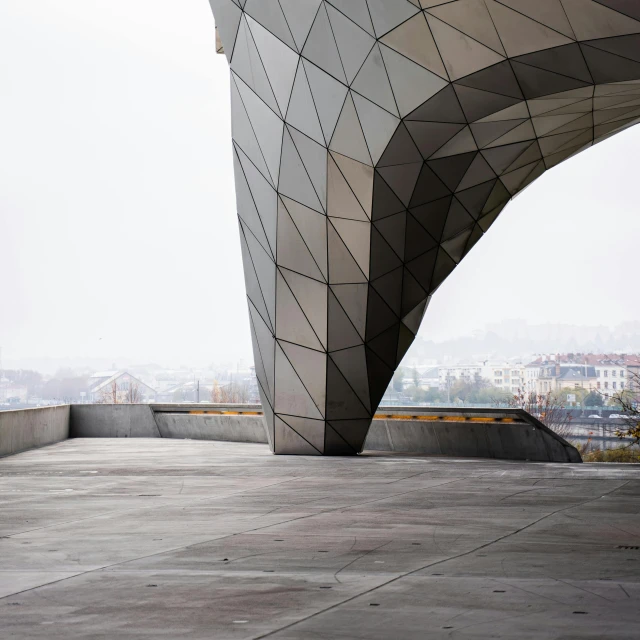 a man riding a skateboard up the side of a building, inspired by Zha Shibiao, unsplash contest winner, concrete art, geodesic architecture, under a gray foggy sky, photo of a big theaterstage, austrian architecture