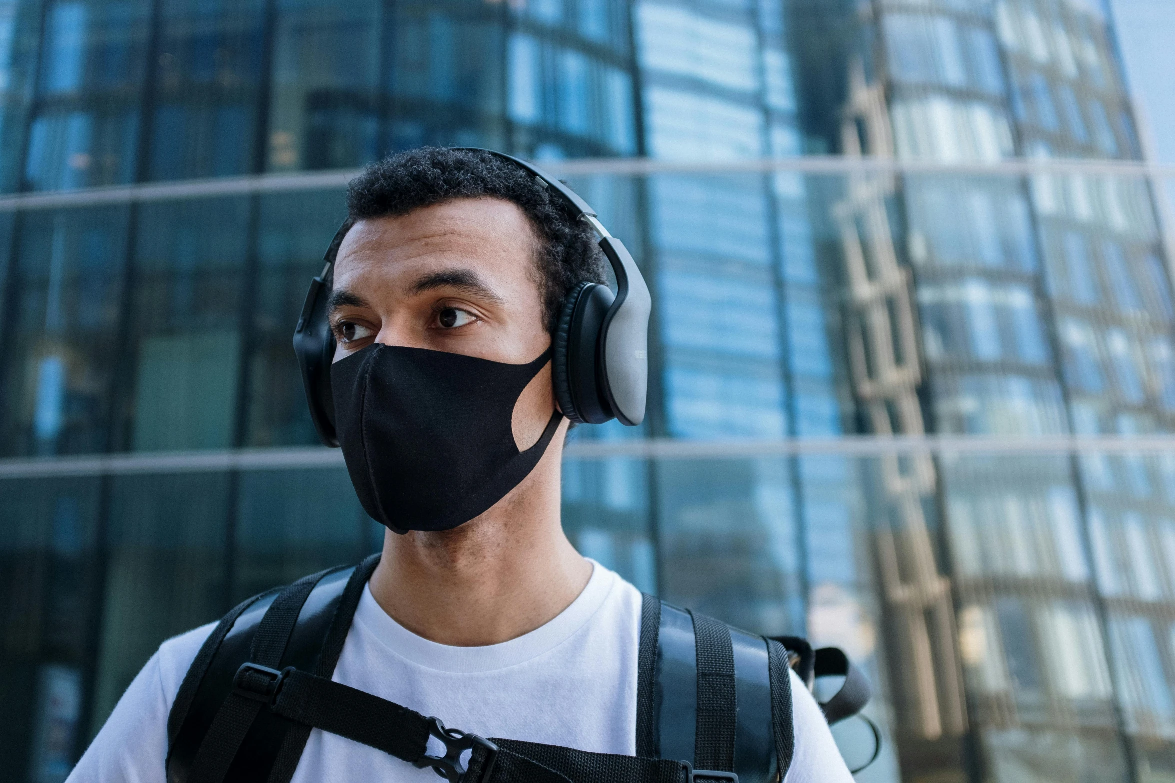 a man wearing headphones and a black mask, pexels contest winner, renaissance, in a cybercity, no - text no - logo, casually dressed, australian