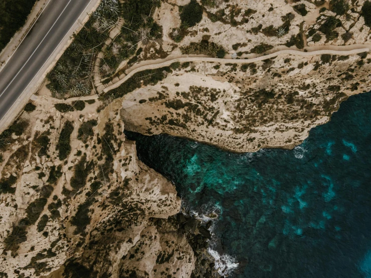 an aerial view of a road next to the ocean, pexels contest winner, les nabis, cyprus, rugged details, teal aesthetic, modeled