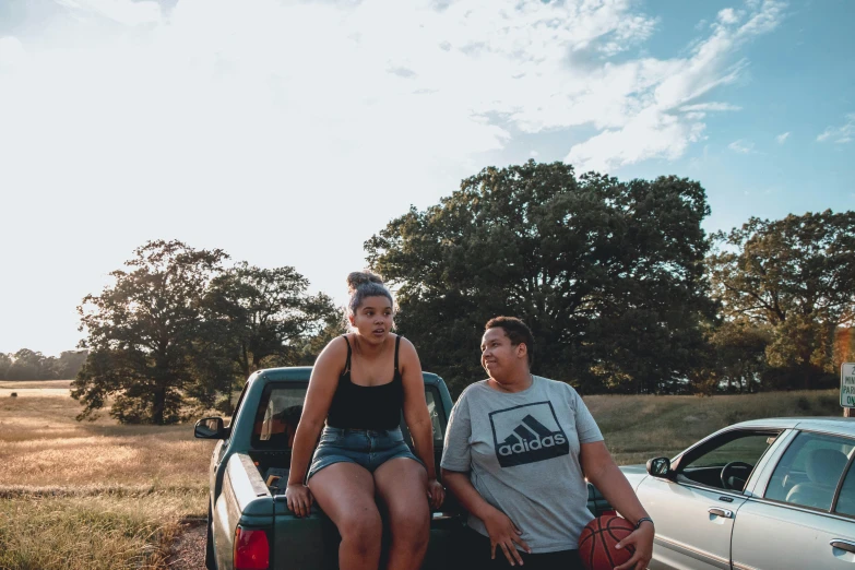 a couple of people that are sitting in the back of a truck, unsplash, thick thighs, teenage boy, on a farm, profile image