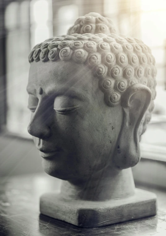 a statue sitting on top of a table next to a window, a marble sculpture, by Glennray Tutor, trending on unsplash, asian face, a beautiful buddhist mandala, close up head shot, singularity sculpted �ー etsy