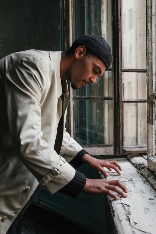 a man in a suit leaning on a window sill, an album cover, pexels contest winner, visual art, wearing newsboy cap, riyahd cassiem, inspect in inventory image, playing piano