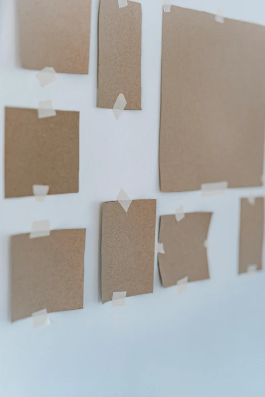several pieces of cardboard taped to a wall, unsplash, conceptual art, square shapes, for displaying recipes, movie filmstill, up close