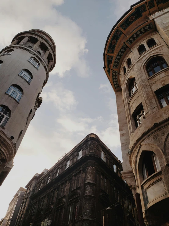 a couple of tall buildings next to each other, a photo, pexels contest winner, art nouveau, budapest, half turned around, low quality photo