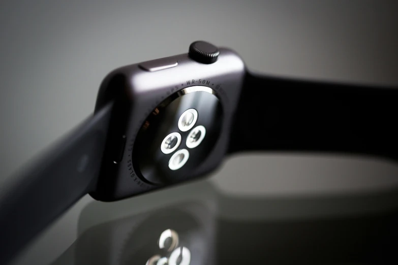 an apple watch sitting on top of a glass table, pexels, photorealism, low - angle shot from behind, square, black matte finish, close up portrait
