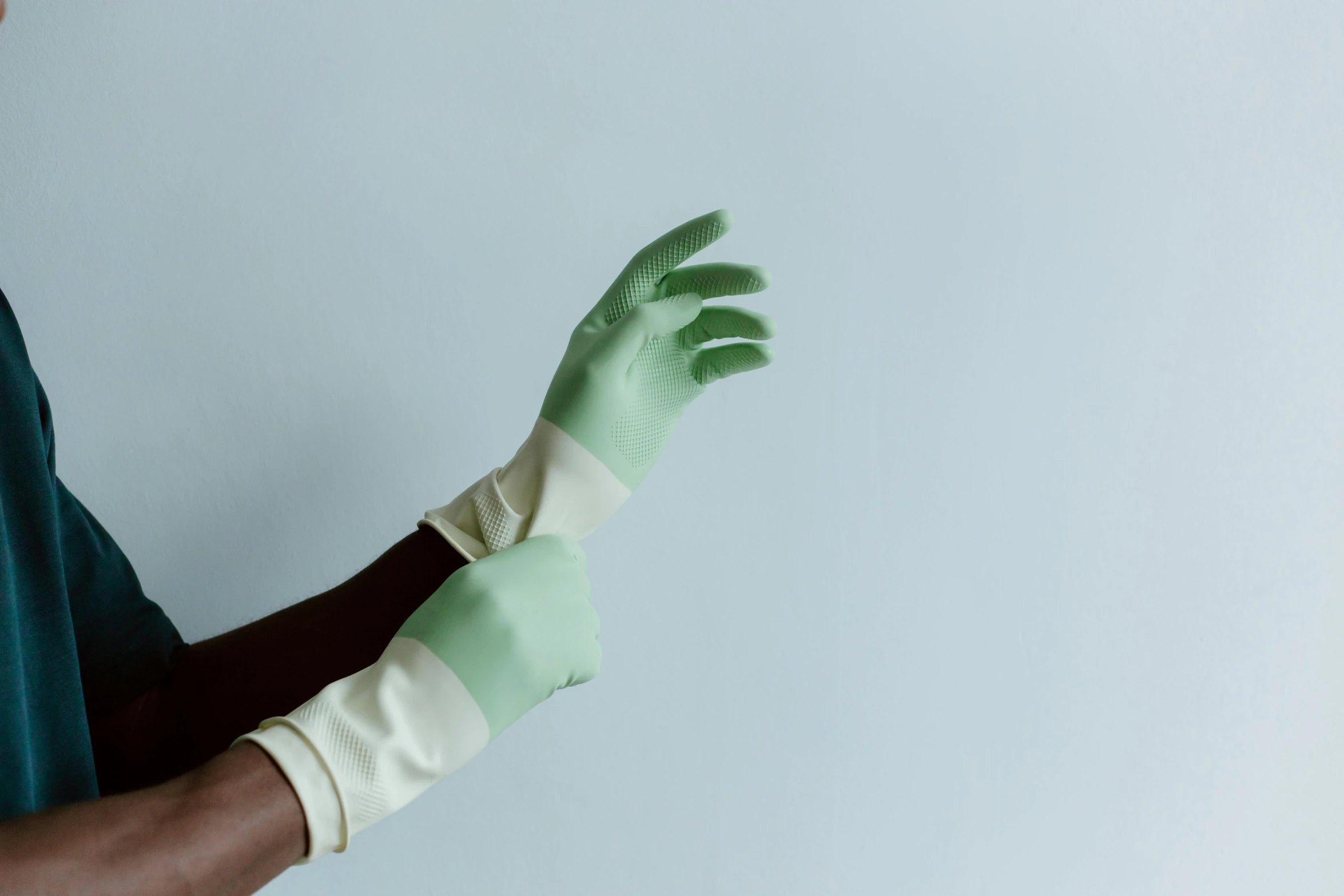 a close up of a person wearing green gloves, unsplash, plasticien, white long gloves, on a pale background, sterile colours, ilustration