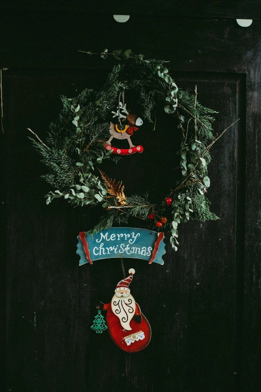 a christmas wreath hanging on the front door of a house, a cartoon, by Julia Pishtar, pexels, folk art, on black background, multiple stories, made of glazed, closeup photograph