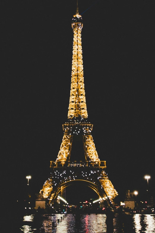 the eiffel tower is lit up at night, poster art, unsplash contest winner, gold and black color scheme, 2000s photo, square, mobile wallpaper