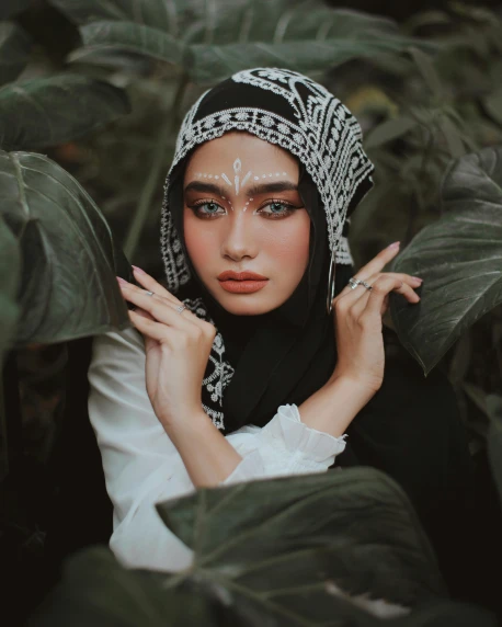 a woman wearing a black and white head scarf, inspired by Sasha Putrya, unsplash contest winner, sumatraism, sitting on a leaf, beauty woman with detailed faces, ☁🌪🌙👩🏾, androgynous male