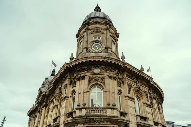 a building with a clock on the top of it, by Joe Bowler, unsplash, art nouveau, hull, square, brown, official courthouse