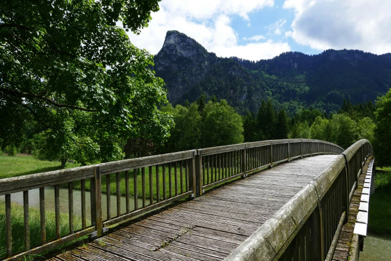 a wooden bridge over a river with mountains in the background, a picture, inspired by Jan Müller, unsplash, renaissance, lower saxony, boardwalk, green, 2 5 6 x 2 5 6 pixels