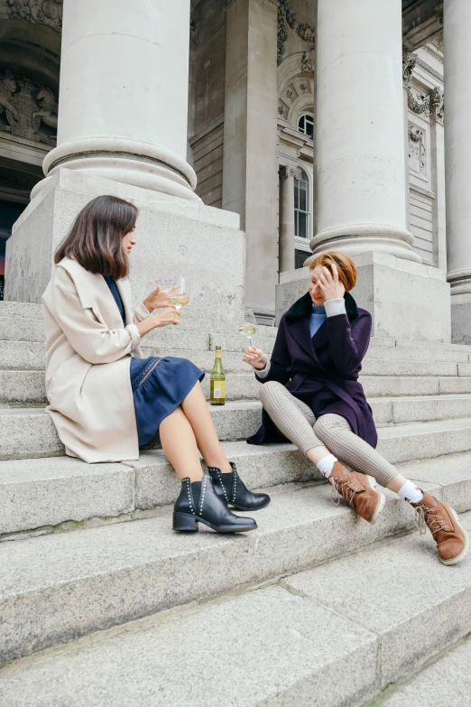 two women sitting on the steps of a building, by Nina Hamnett, trending on unsplash, renaissance, drinking alcohol, smart casual, post graduate, autumnal