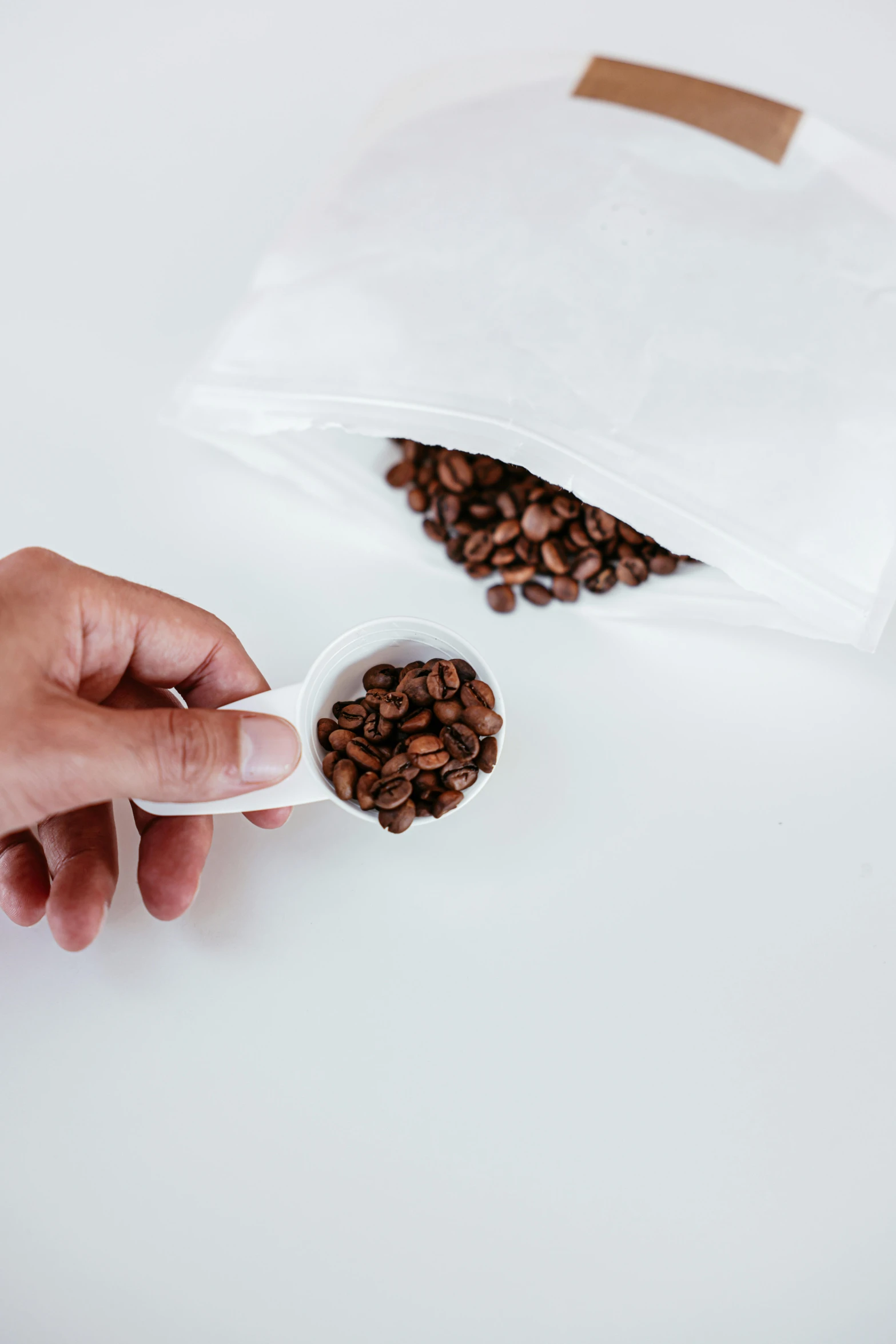 a person scooping coffee beans out of a bag, product view, highly capsuled, porcelain, highly upvoted