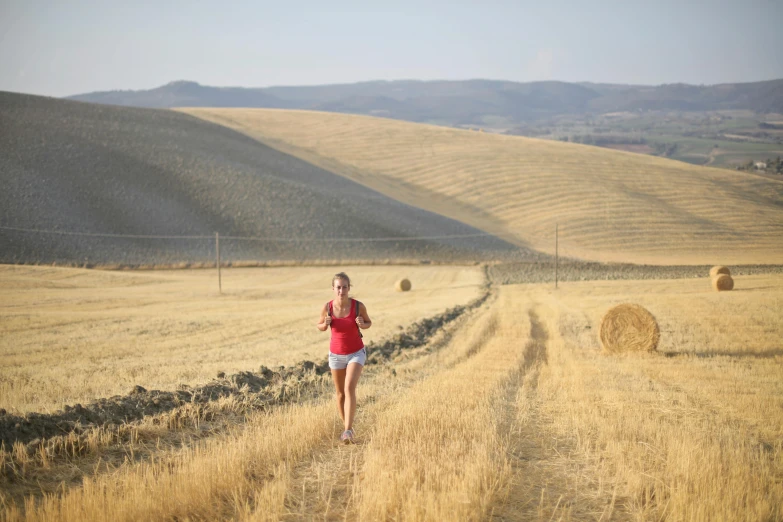 a woman running down a dirt road in a field, by Francesco Furini, avatar image