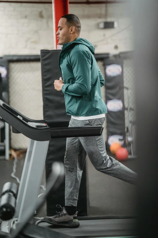 a man running on a treadmill in a gym, by Jakob Gauermann, dribble, happening, grey hoodie opened, full body image, banner, aussie