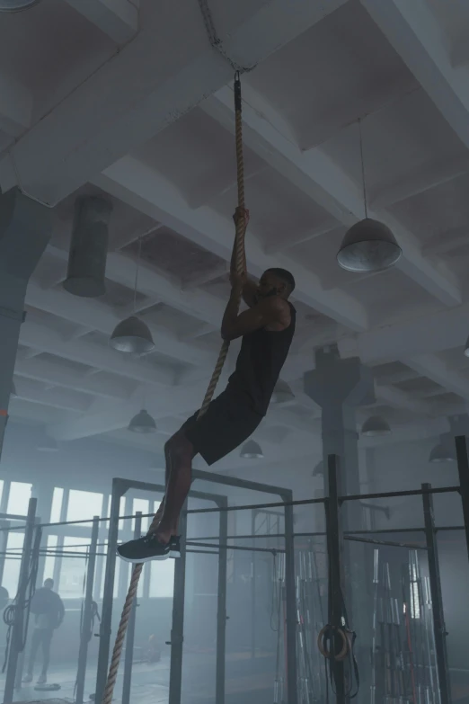 a man hanging from a rope in a gym, pexels contest winner, realism, 2 0 2 1 cinematic 4 k framegrab, ignant, square, athletic crossfit build