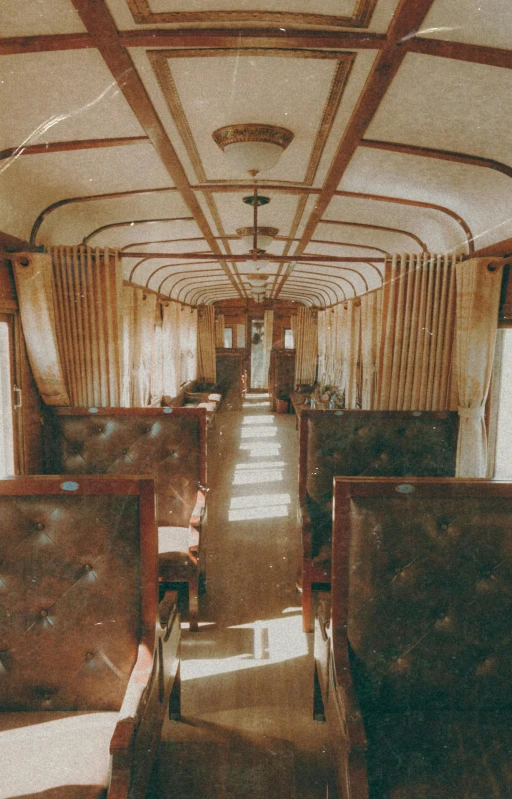 a view of the inside of a train car, by Abram Arkhipov, unsplash, art nouveau, photo taken on fujifilm superia, panoramic view, brown, saloon exterior