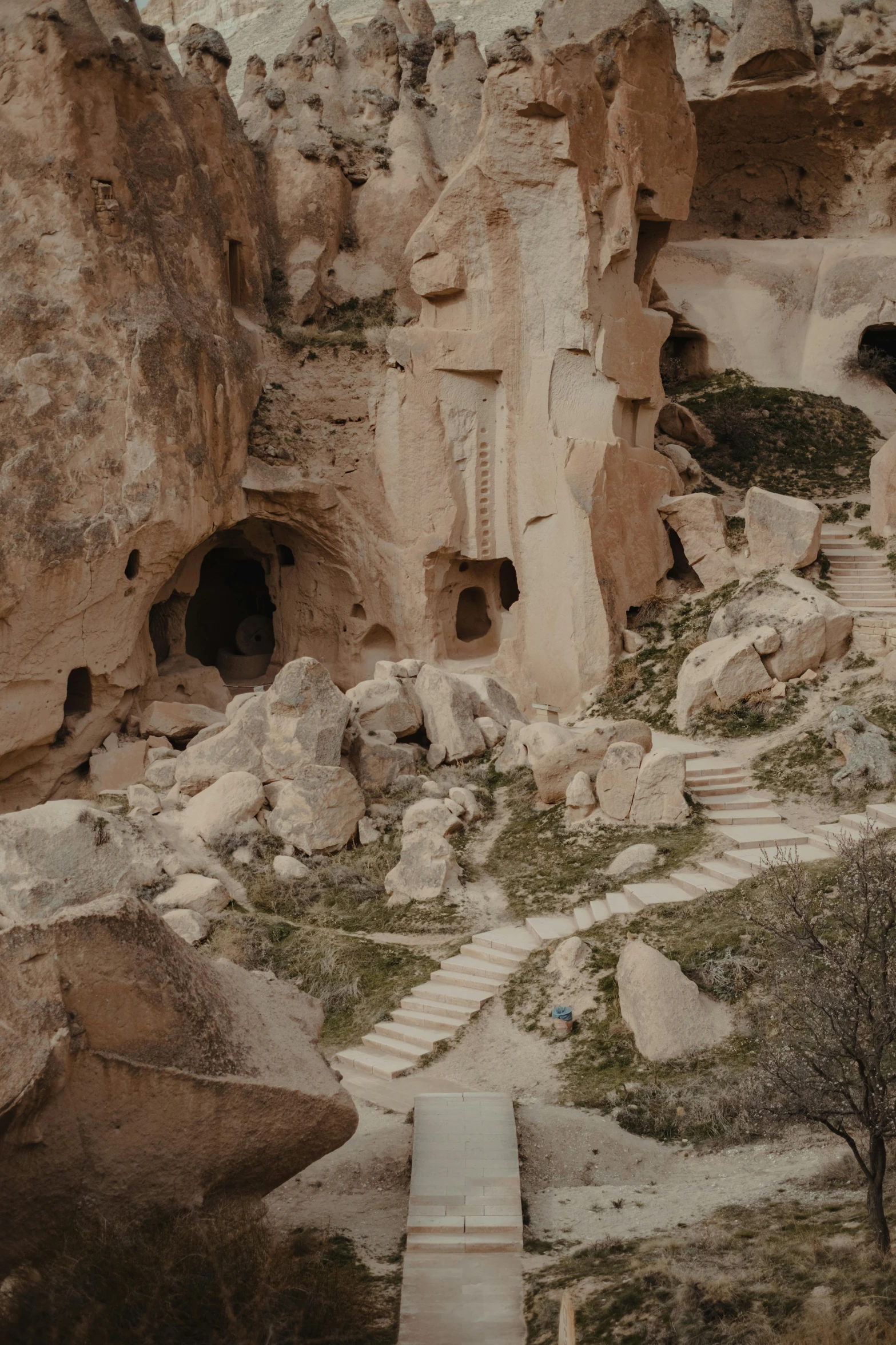 a group of stairs going up the side of a mountain, a detailed matte painting, by Muggur, pexels contest winner, art nouveau, turkey, cozy bathhouse hidden in a cave, 4 k photo autochrome, tall stone spires