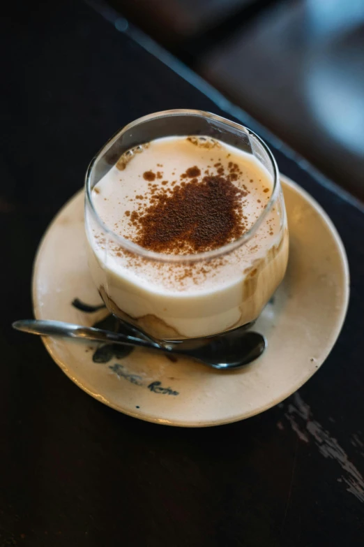 a close up of a cup of coffee on a saucer, vanilla smoothie explosion, afar, thumbnail, moroccan