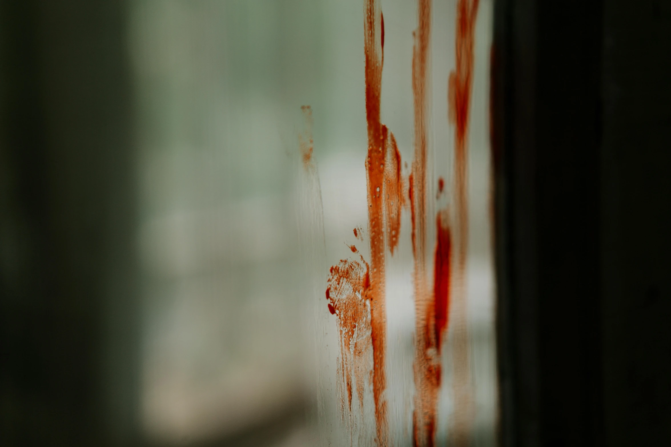 a close up of a window with blood on it, by Elsa Bleda, pexels contest winner, hurufiyya, documentary still, bloody knife, scratched, serial killer