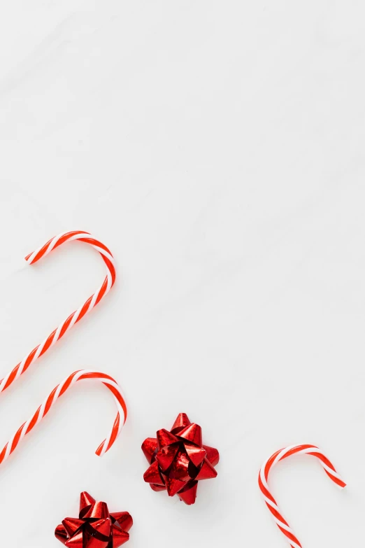 a couple of candy canes sitting on top of a table, pexels, minimalism, square, banner, glossy white, 1 2 9 7