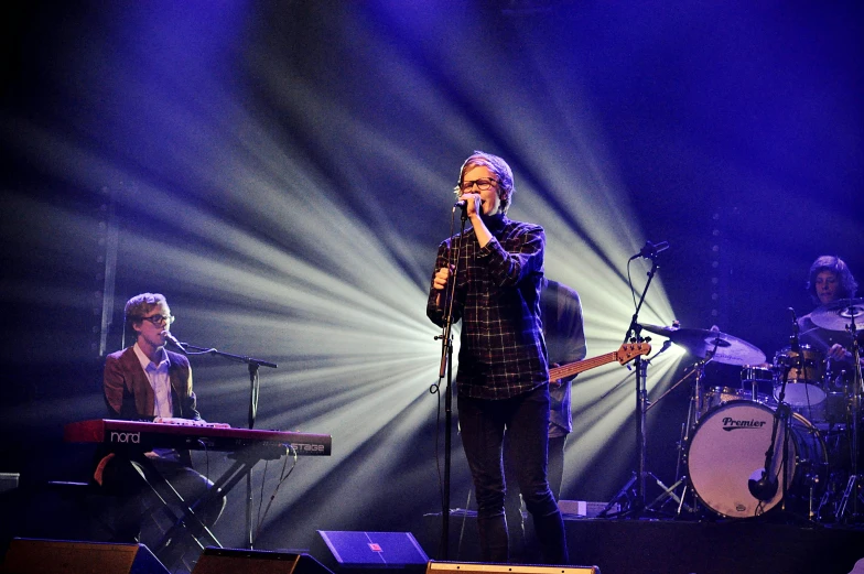 a man that is standing in front of a microphone, an album cover, pexels, antipodeans, panoramic shot, julia hetta, performing on stage, joe pera