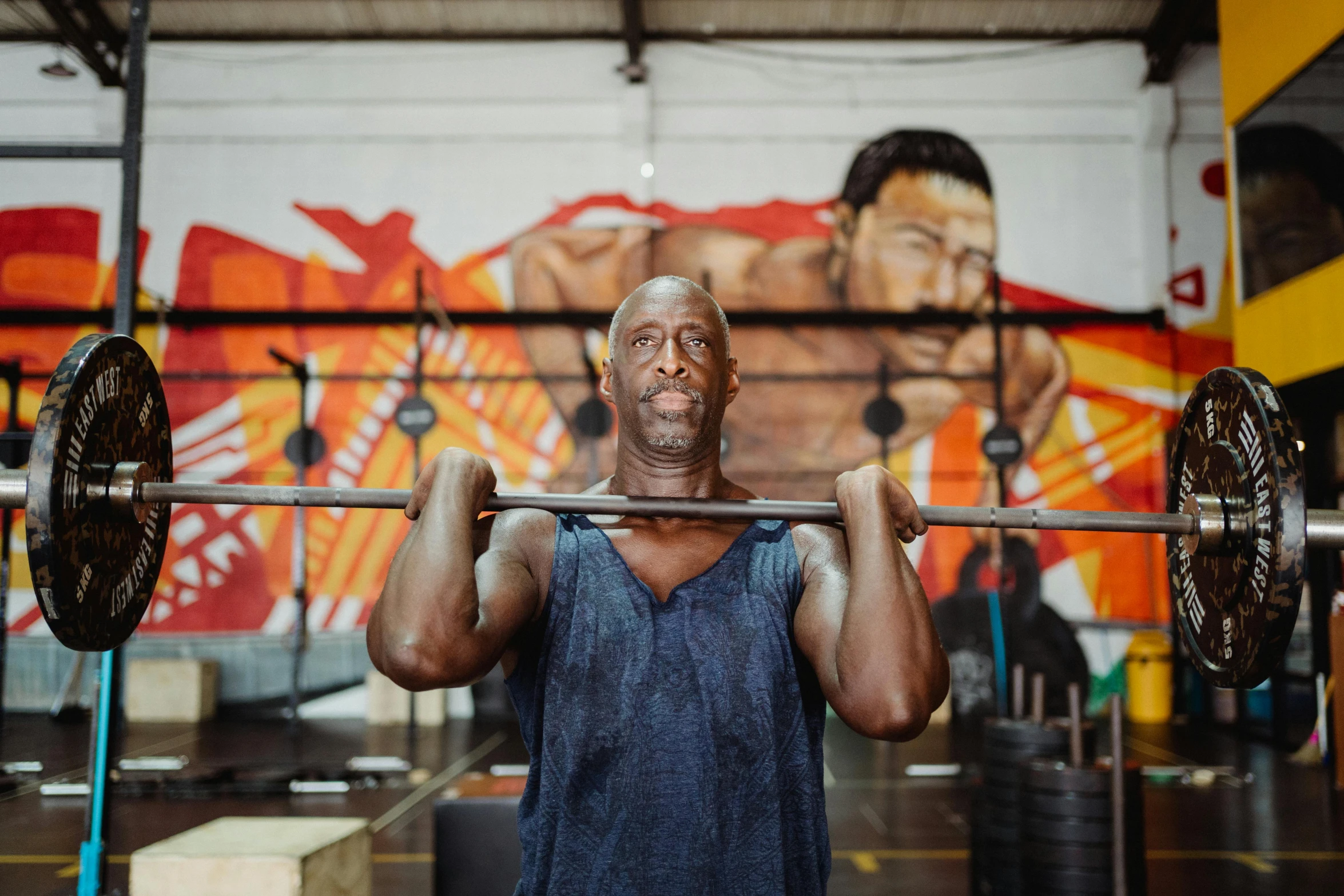 a man lifting a barbell in a gym, a portrait, pexels contest winner, process art, lance reddick, lachlan bailey, local gym, 4 5 yo