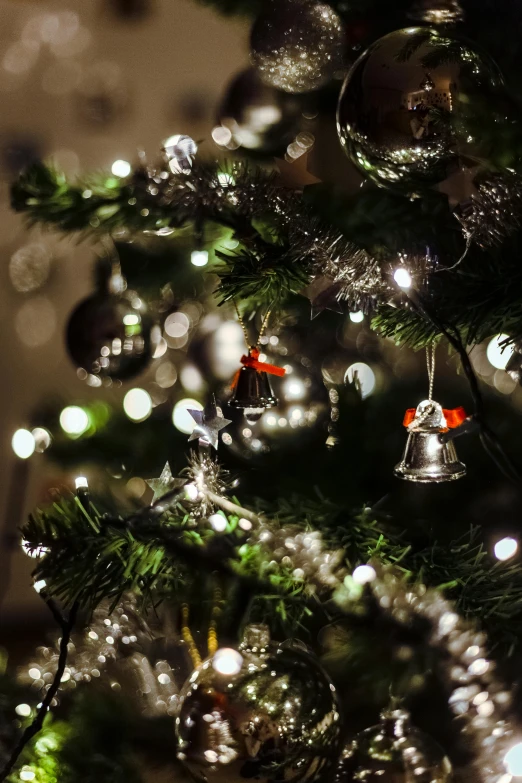 a close up of a christmas tree with ornaments, by Jakob Gauermann, happening, dappled silver lighting, bells, thumbnail, the best