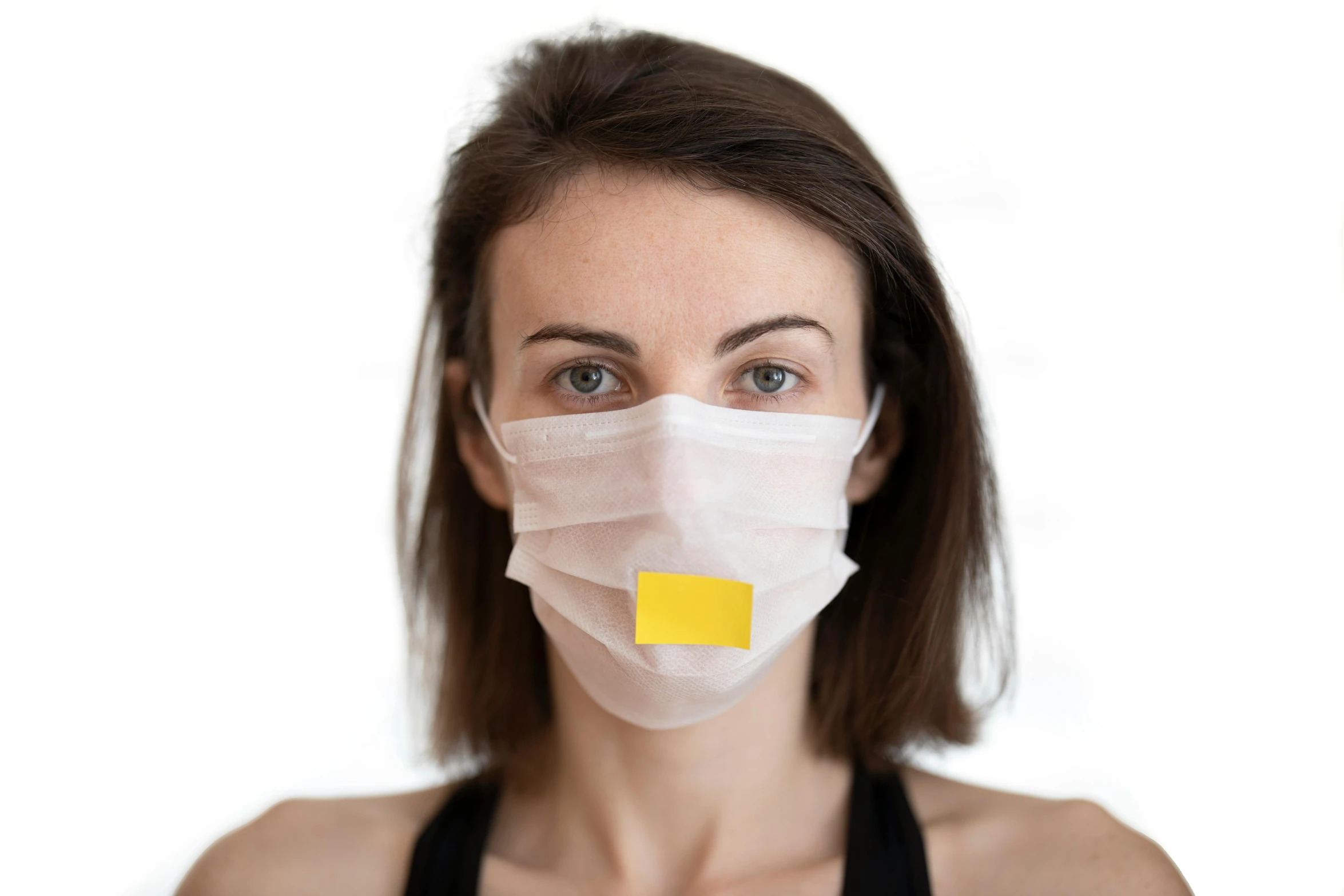 a woman with a mask covering her face, a picture, medical labels, yellow, with a white background, pout